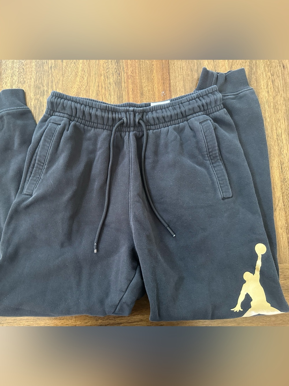 Nike Jordan Essential Black Sweatpants with Gold Jumpman Graphic